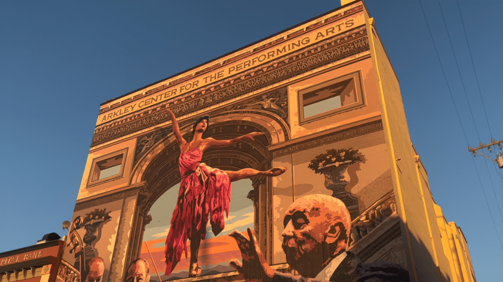 woman dancing mural on the side of a building