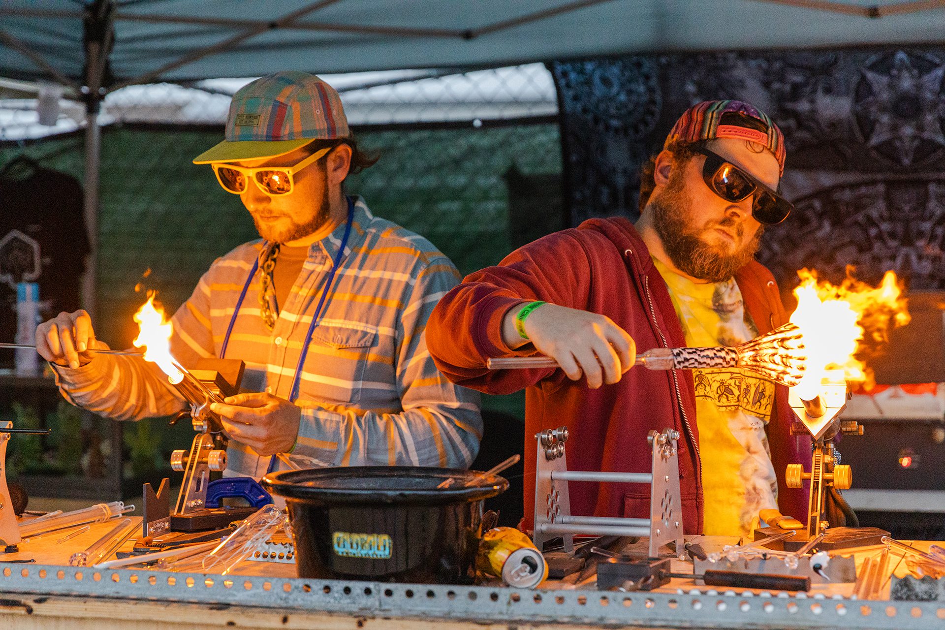 Two men using fire to make something during Cannifest