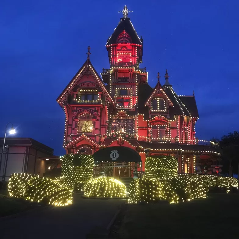 Carson Mansion lit up with lights at night