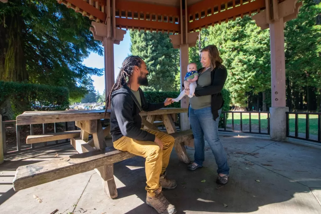 couple with a baby under a gazebo