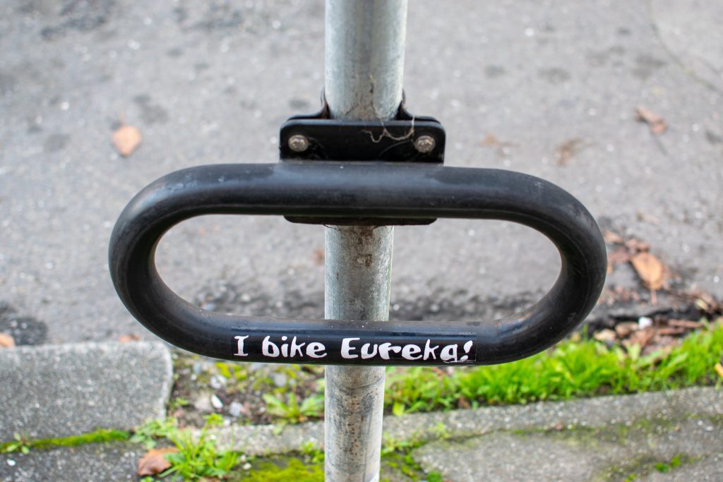 Metal bicycle rack that says "I bike Eureka!"