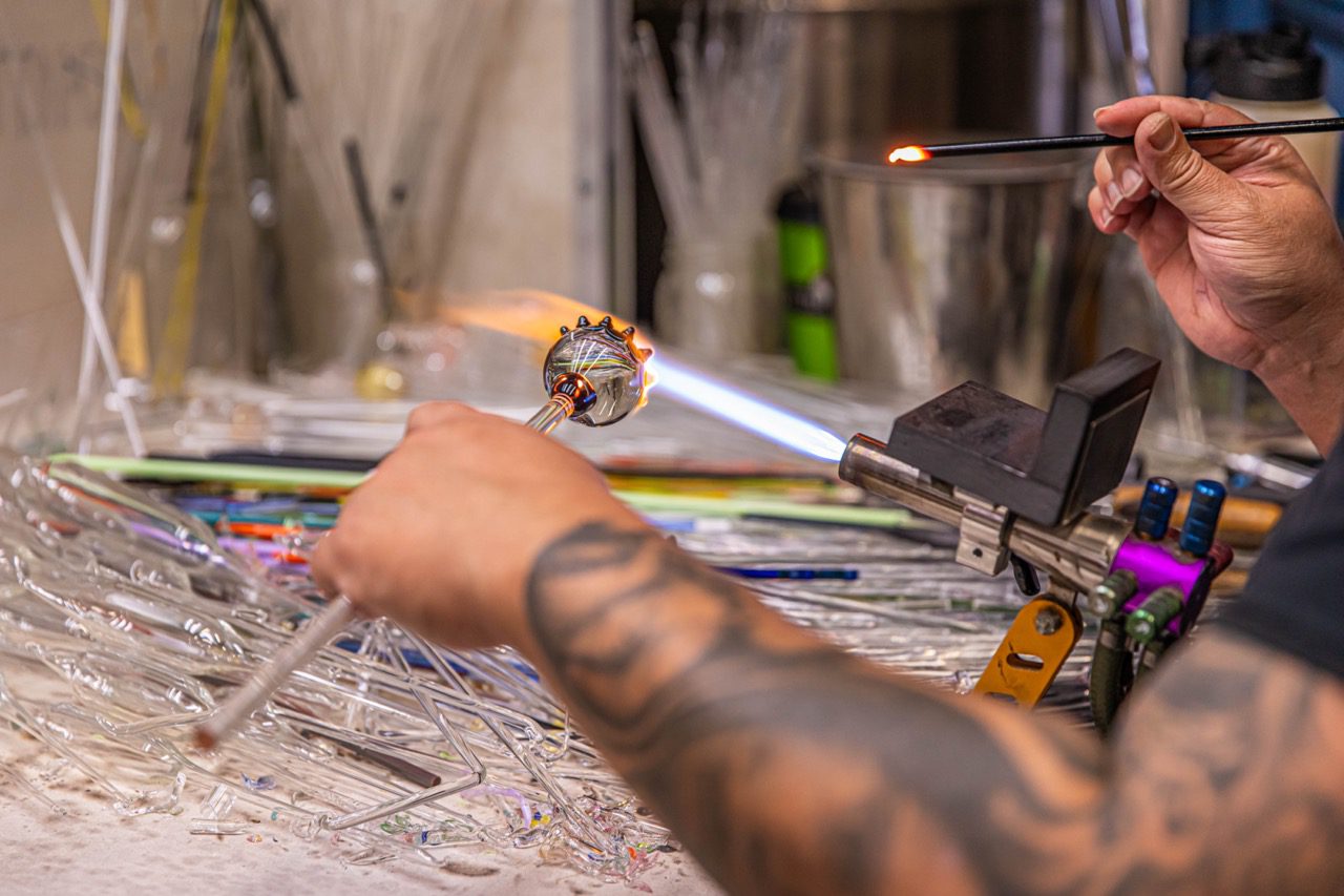 Close up of someone making class art with a blow torch