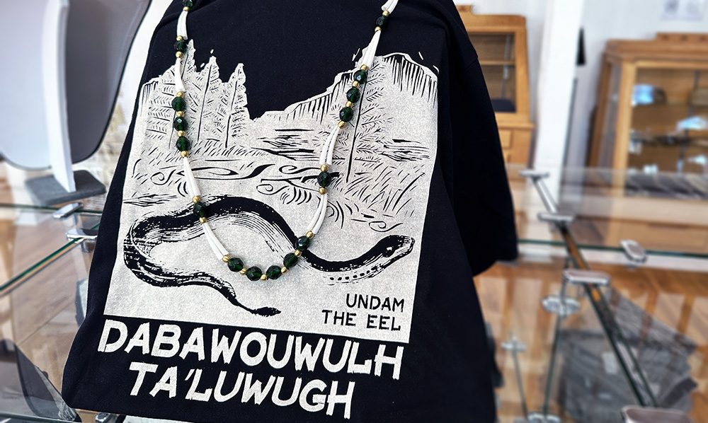 Indigenous text on black and white shirt